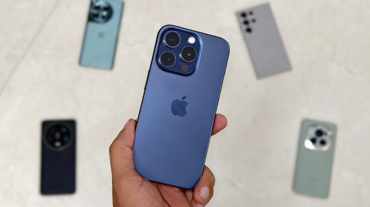 Image 1: iPhone 15 Pro surrounded by other phones